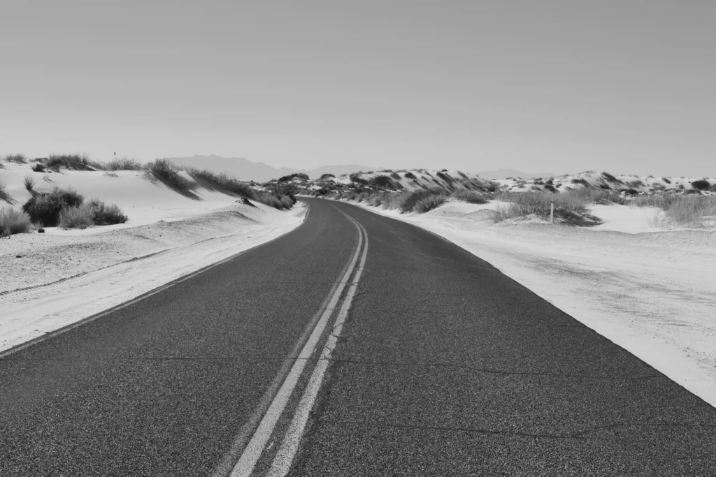 Black and White Photo of road crossing the desert - Life's Journey is filled with expectations and disappointments