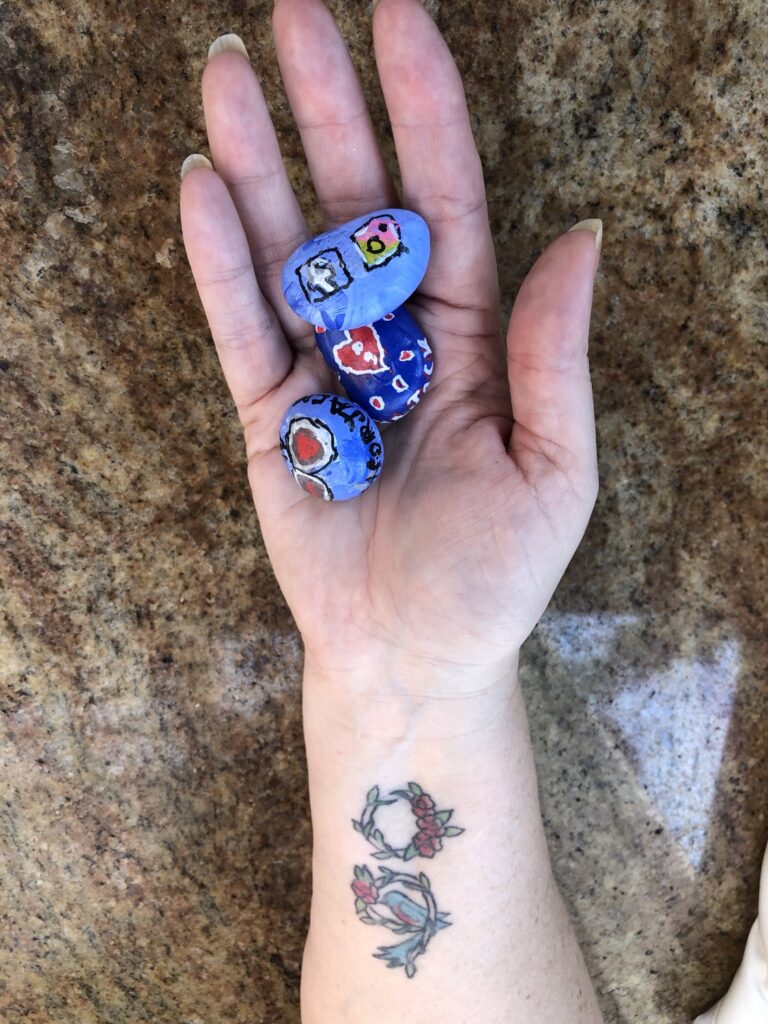 Photo of semi-colon tattoo on arm and painted rocks - Your Story doesn't have to end